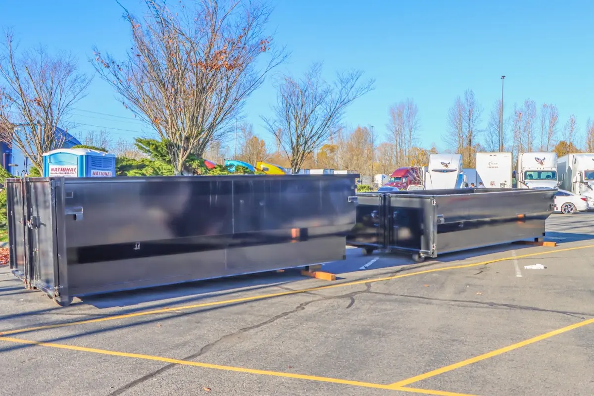 Professional dumpster rental service with roll-off container on residential driveway in Shasta Lake